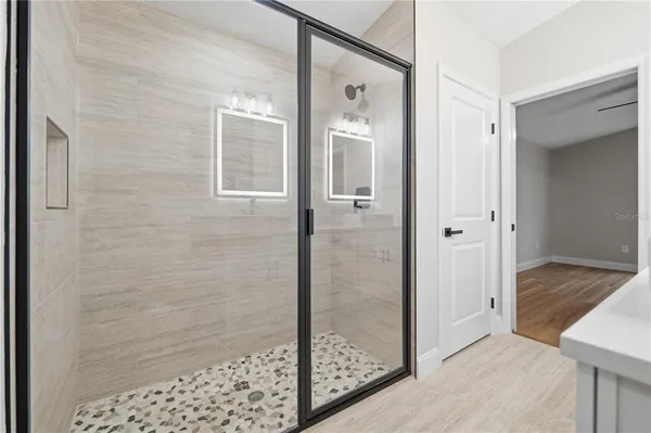 a bathroom with a shower and a sink