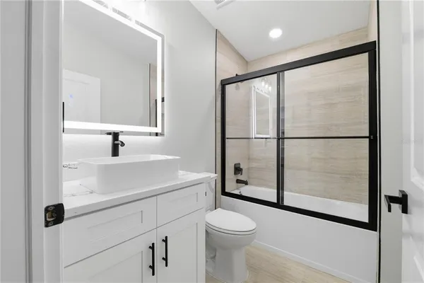 a bathroom with a sink toilet and shower