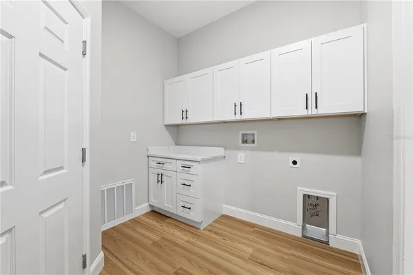 a view of an empty room and cabinet