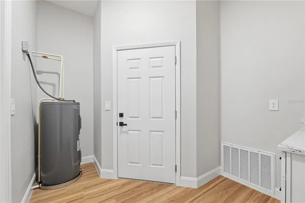 a view of a room with wooden floor and hallway