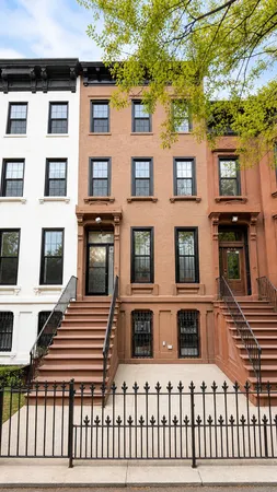 a view of a brick building next to a yard