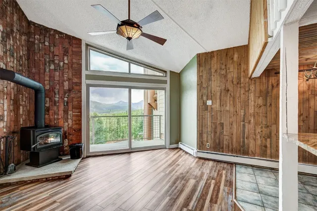 a view of a livingroom with wooden floor and balcony