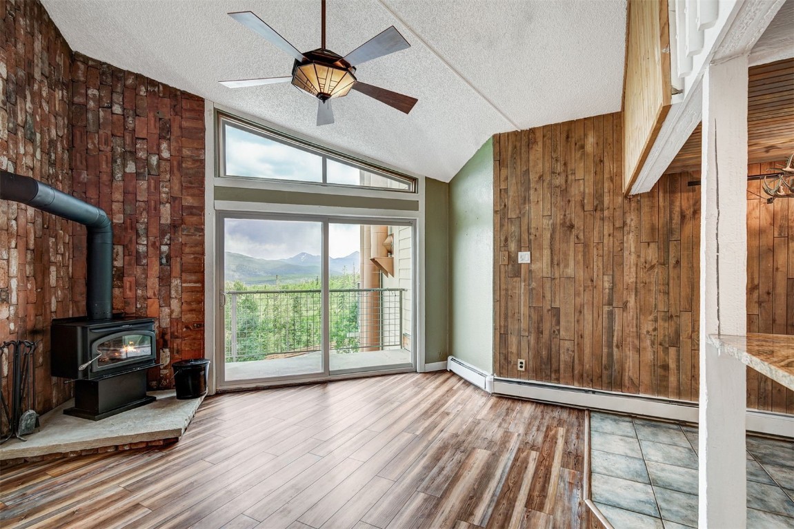 a view of a livingroom with wooden floor and balcony