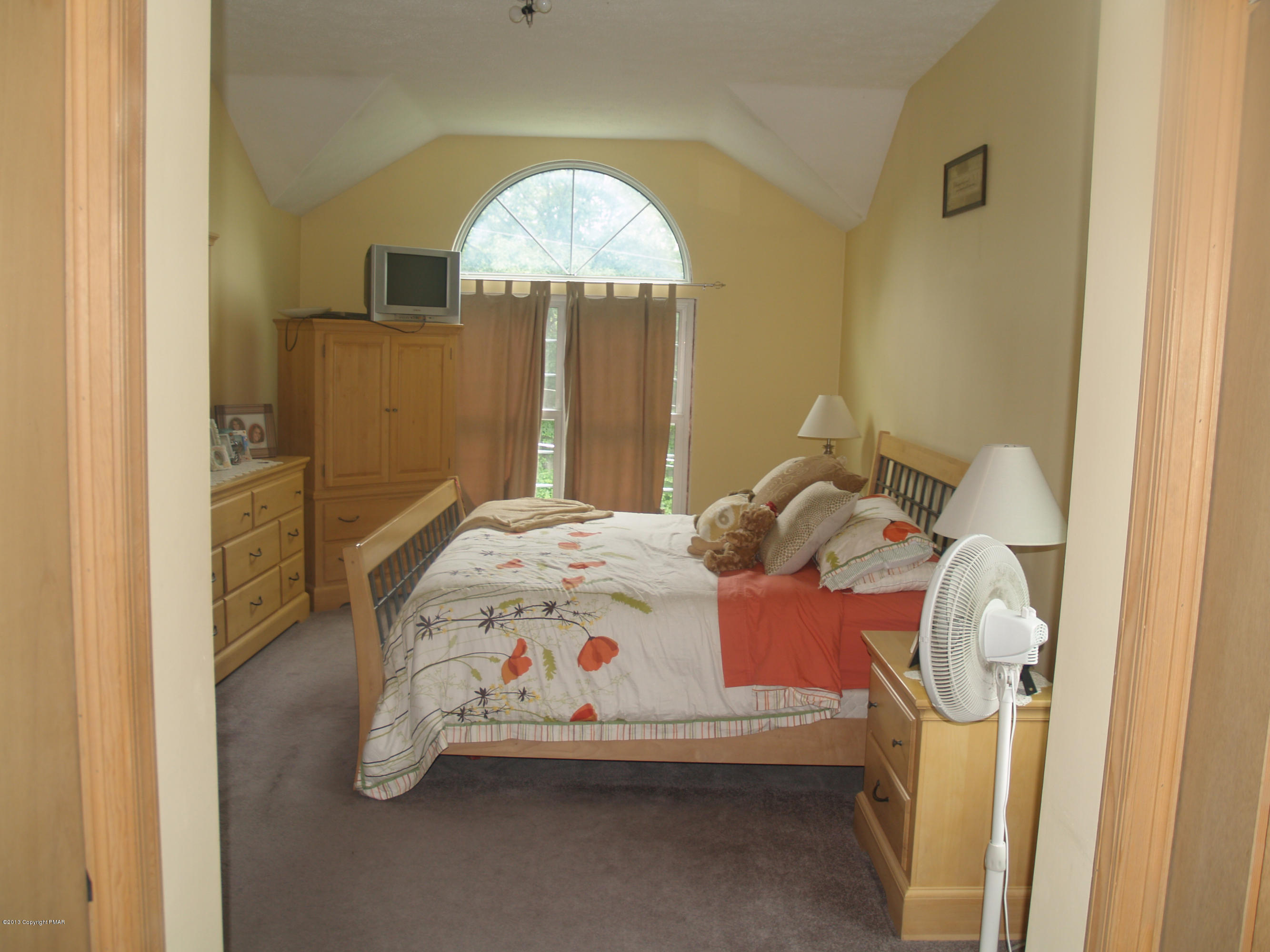 17 Dancing Ridge Road East Stroudsburg, PA 18302 - Photo 13 of 44 a bedroom with a bed and a chandelier