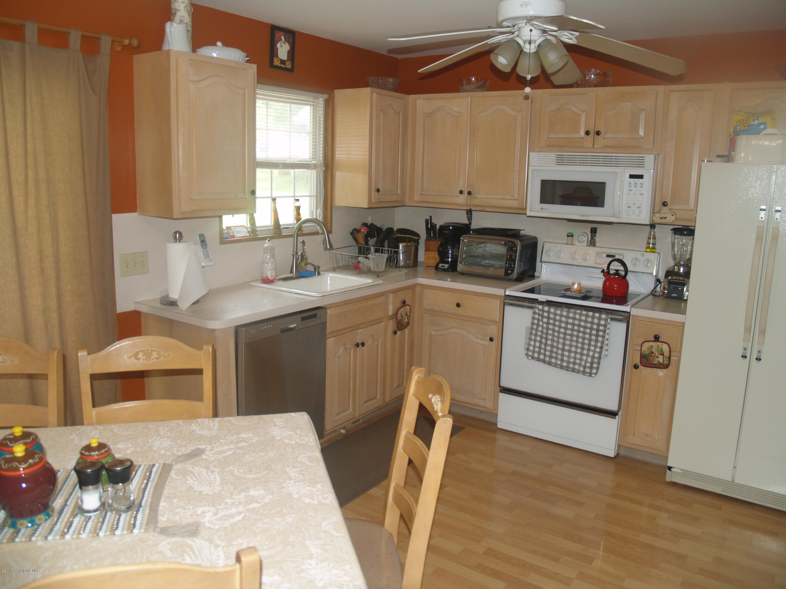 17 Dancing Ridge Road East Stroudsburg, PA 18302 - Photo 6 of 44 a kitchen with stainless steel appliances kitchen island granite countertop a sink dishwasher a stove a refrigerator and cabinets with wooden floor