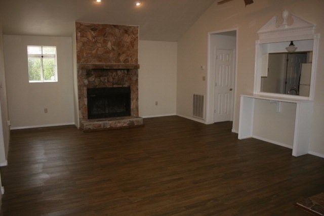 4648 Jones Road Macon, GA 31216 - Photo 3 of 10 an empty room with wooden floor a fireplace and windows