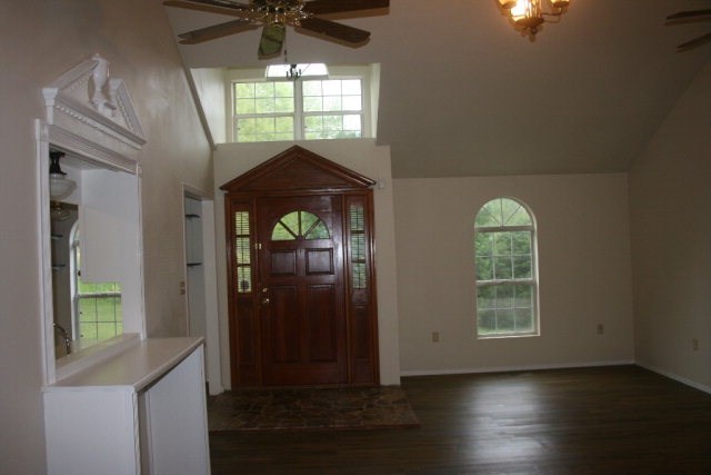 4648 Jones Road Macon, GA 31216 - Photo 4 of 10 an empty room with wooden floor fan and windows