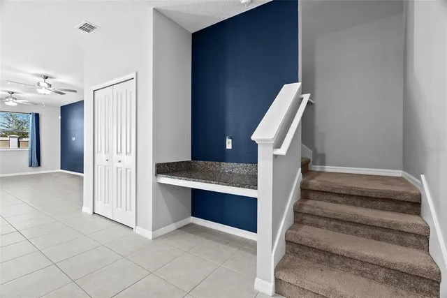 an empty room with closet and fan