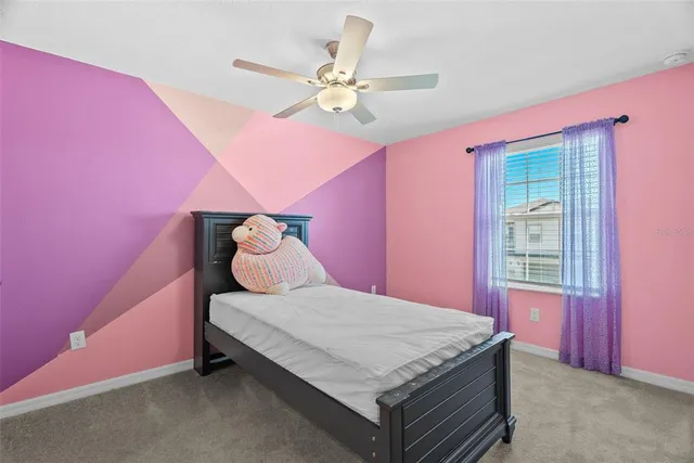 a bedroom with a bed chandelier and a closet