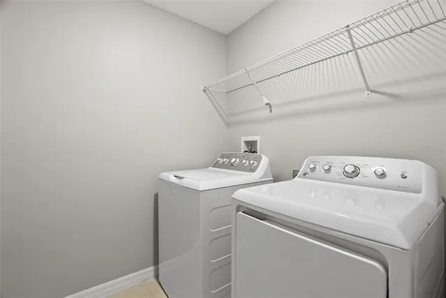 a view of a room with a ceiling fan