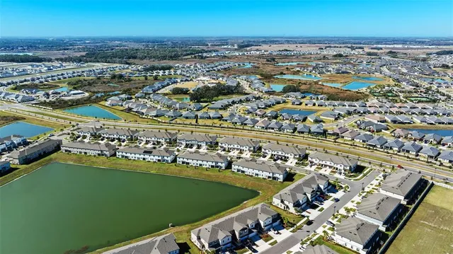 an aerial view of a residential building with outdoor space