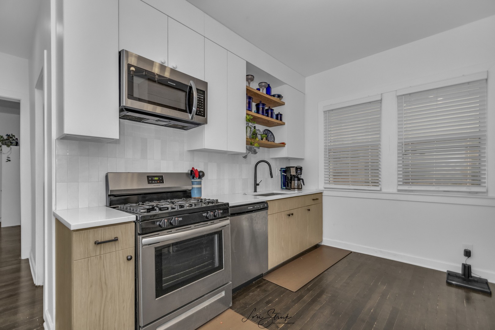 3637 North Pulaski Road Chicago, IL 60641 - Photo 9 of 34 a kitchen with stainless steel appliances a stove a sink and wooden floor