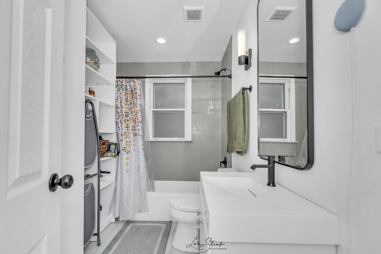 3637 North Pulaski Road Chicago, IL 60641 - Photo 10 of 34 a bathroom with a sink a toilet and a large mirror