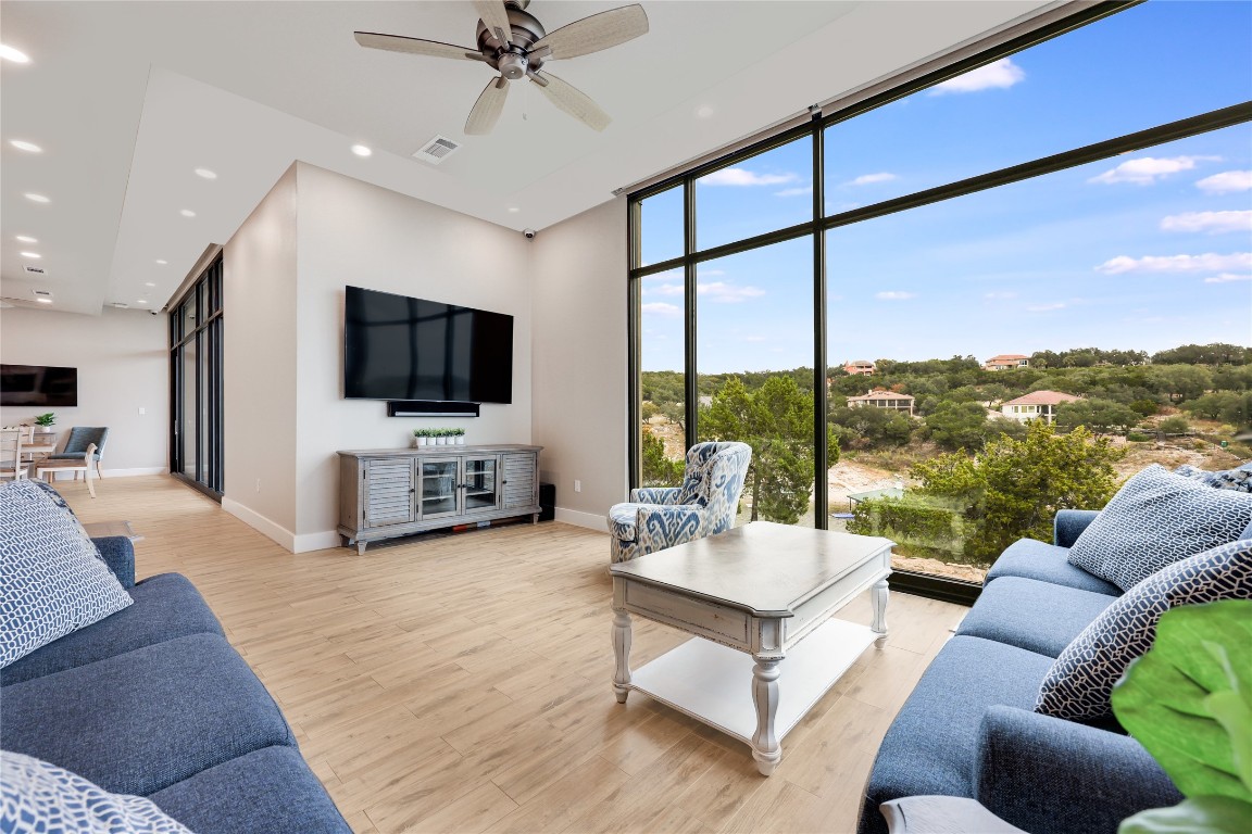 1101 Ivean Pearson Road, Unit B103 Lago Vista, TX 78645 - Photo 39 of 39 a living room with furniture a flat screen tv and a large window