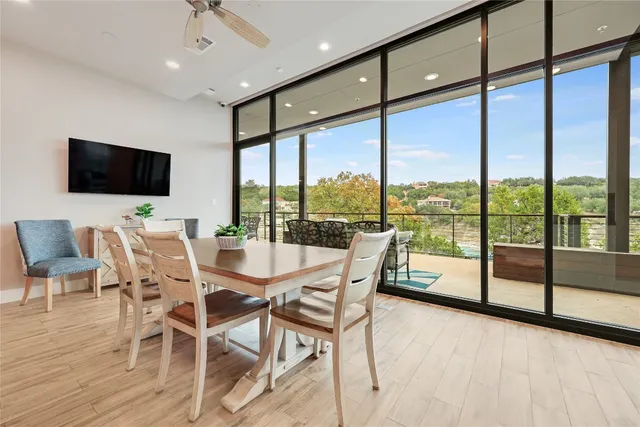 a dining room with furniture window and wooden floor
