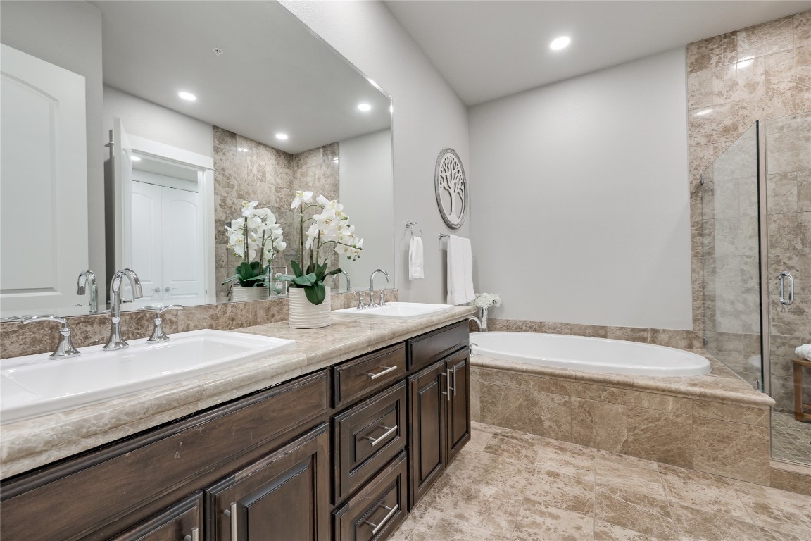 1101 Ivean Pearson Road, Unit B103 Lago Vista, TX 78645 - Photo 25 of 39 a bathroom with a double vanity sink and a bathtub