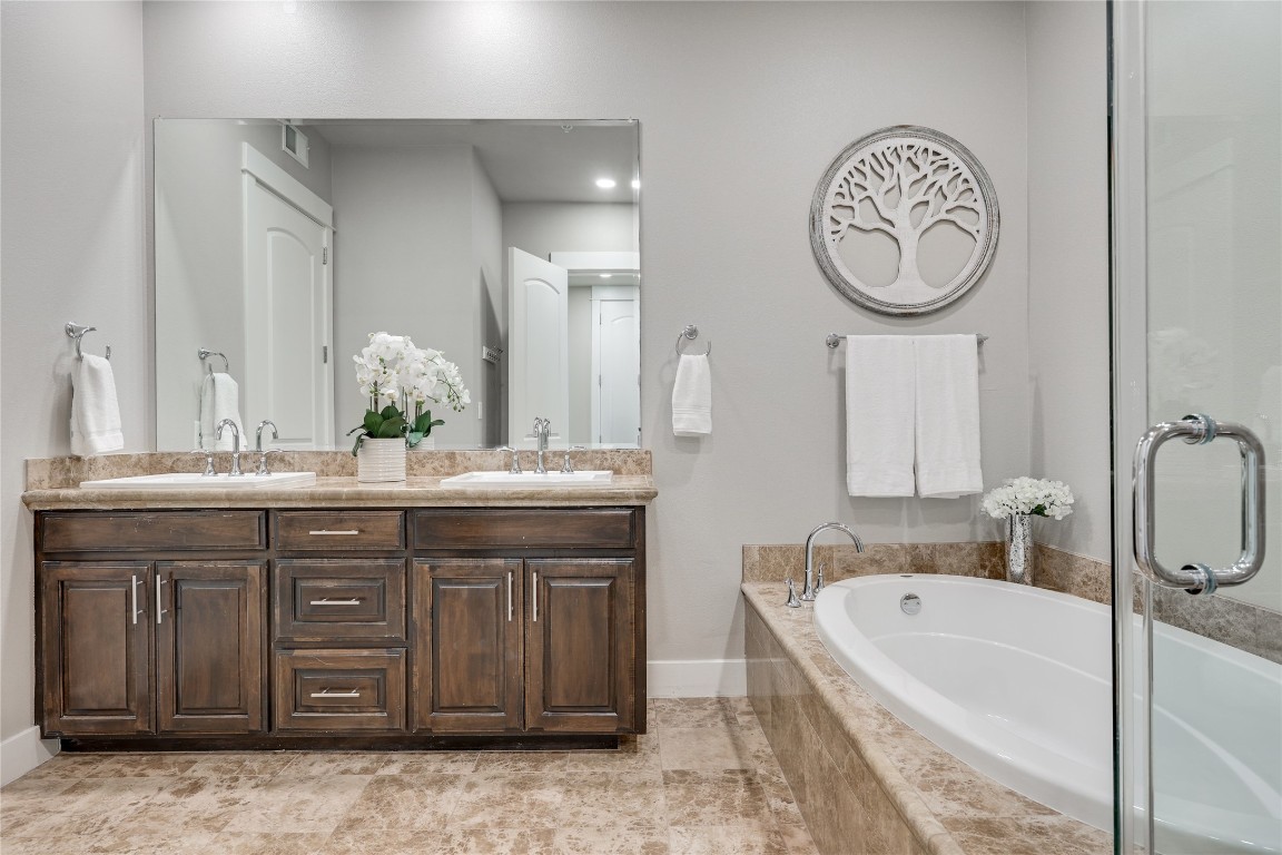 1101 Ivean Pearson Road, Unit B103 Lago Vista, TX 78645 - Photo 26 of 39 a bathroom with a granite countertop sink mirror and bathtub