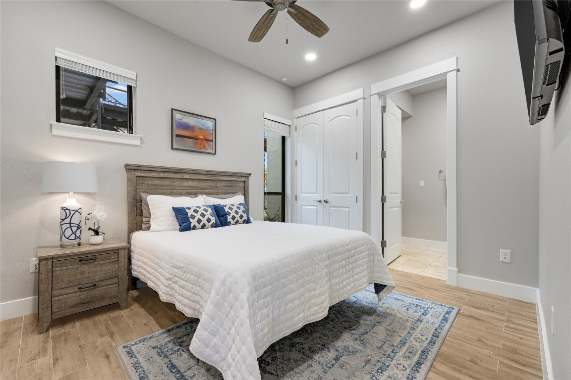 1101 Ivean Pearson Road, Unit B103 Lago Vista, TX 78645 - Photo 28 of 39 a bedroom with a bed and a chandelier