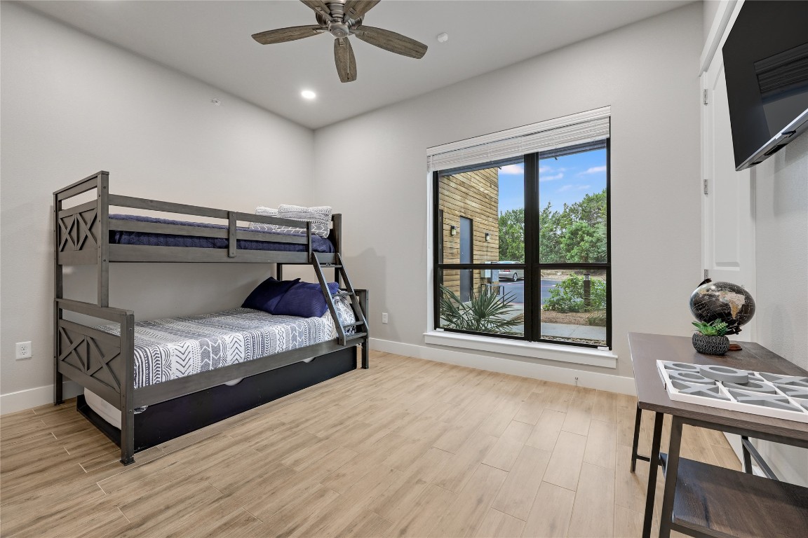 1101 Ivean Pearson Road, Unit B103 Lago Vista, TX 78645 - Photo 31 of 39 a bedroom with a bed and large windows