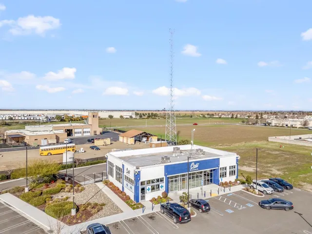 a terrace with outdoor seating and city view