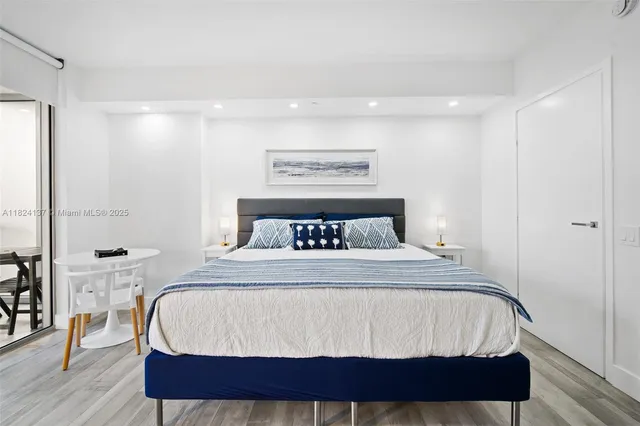 a bedroom with a bed and wooden floor