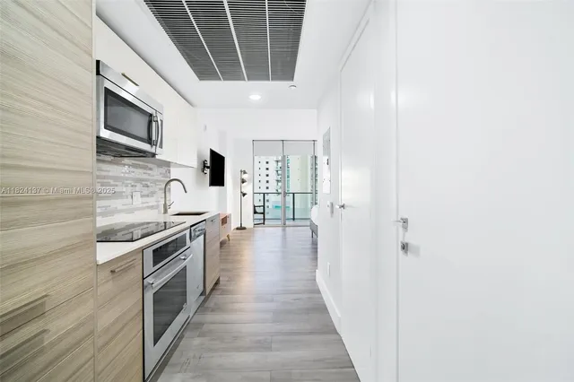 a kitchen with stainless steel appliances granite countertop a stove and a refrigerator