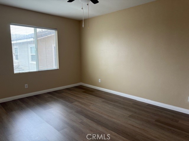 13272 Cool Meadow Drive Eastvale, CA 92880 - Photo 11 of 15 a view of an empty room with wooden floor and a window