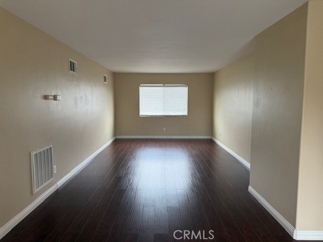 13272 Cool Meadow Drive Eastvale, CA 92880 - Photo 13 of 15 an empty room with wooden floor and windows