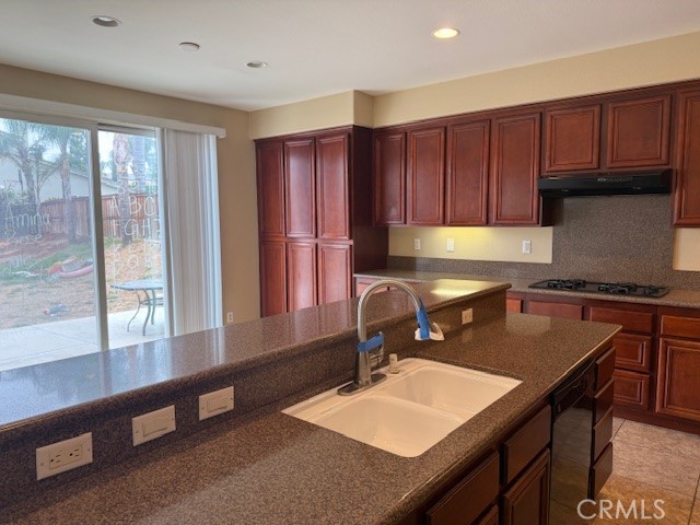13272 Cool Meadow Drive Eastvale, CA 92880 - Photo 3 of 15 a kitchen with a sink a counter and chairs