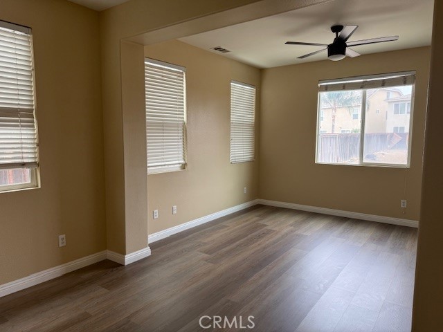 13272 Cool Meadow Drive Eastvale, CA 92880 - Photo 6 of 15 an empty room with wooden floor and windows