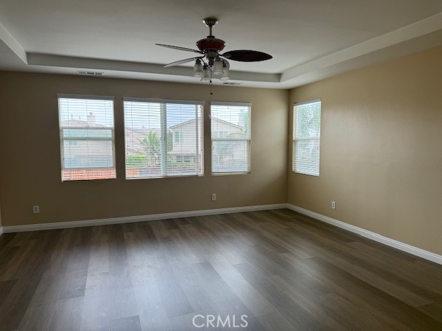 13272 Cool Meadow Drive Eastvale, CA 92880 - Photo 7 of 15 a view of an empty room with wooden floor and a window