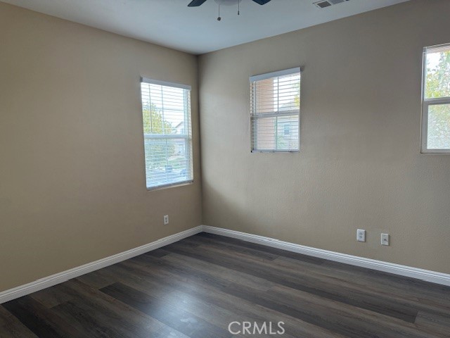 13272 Cool Meadow Drive Eastvale, CA 92880 - Photo 10 of 15 an empty room with wooden floor and windows