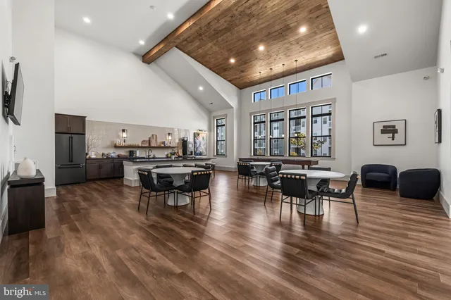 a living room with lots of furniture and kitchen view