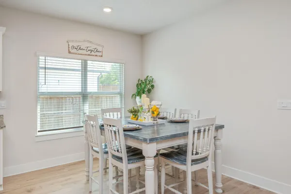 a view of a dining room with furniture and window