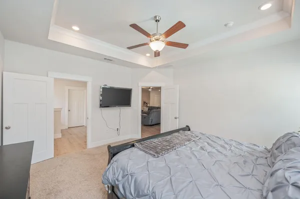 a bedroom with a large bed and a flat screen tv
