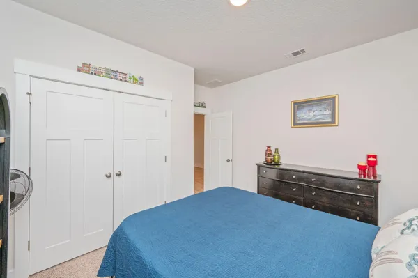 a bedroom with a bed and a closet