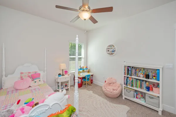 a bedroom with toys and a book shelf