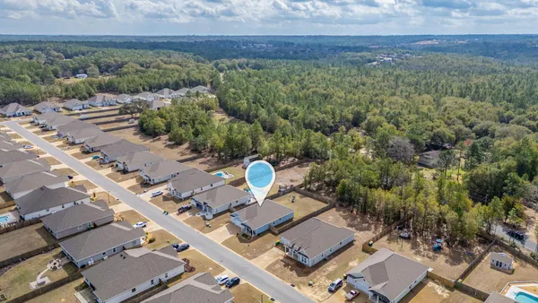 an aerial view of a house with a yard