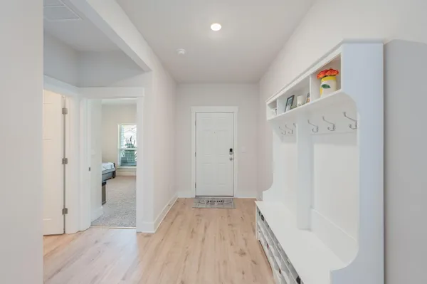 a view of hallway with wooden floor