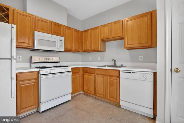 a kitchen with appliances cabinets and a sink