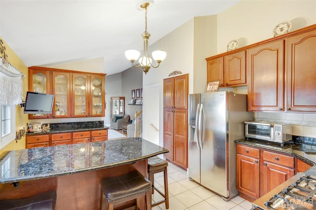 26 Rugby Road Colonia, NJ 07067 - Photo 3 of 23 a kitchen with stainless steel appliances granite countertop a refrigerator a sink and a stove
