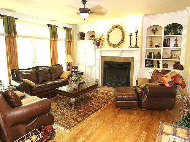 8810 Fidelis Lane Raleigh, NC 27613 - Photo 2 of 10 a living room with furniture a fireplace and a large window