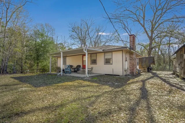 a view of a house with a yard and sitting area