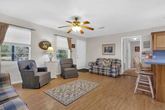a living room with furniture and wooden floor