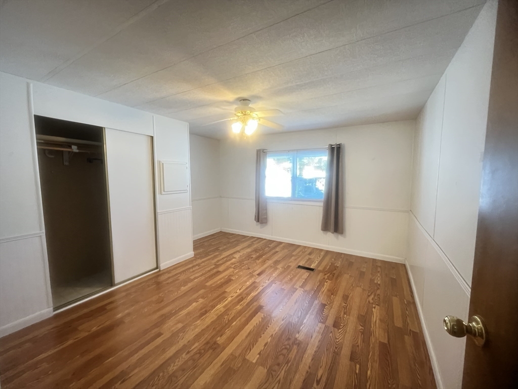 4 Joseph Street Wareham, MA 02538 - Photo 11 of 16 wooden floor in an empty room with a window