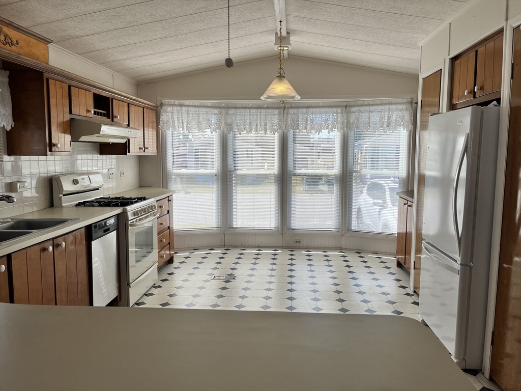 4 Joseph Street Wareham, MA 02538 - Photo 6 of 23 a kitchen with stainless steel appliances granite countertop a refrigerator a stove and a sink