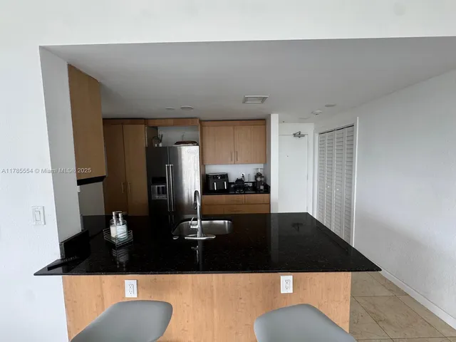 a view of kitchen and living room with a sink
