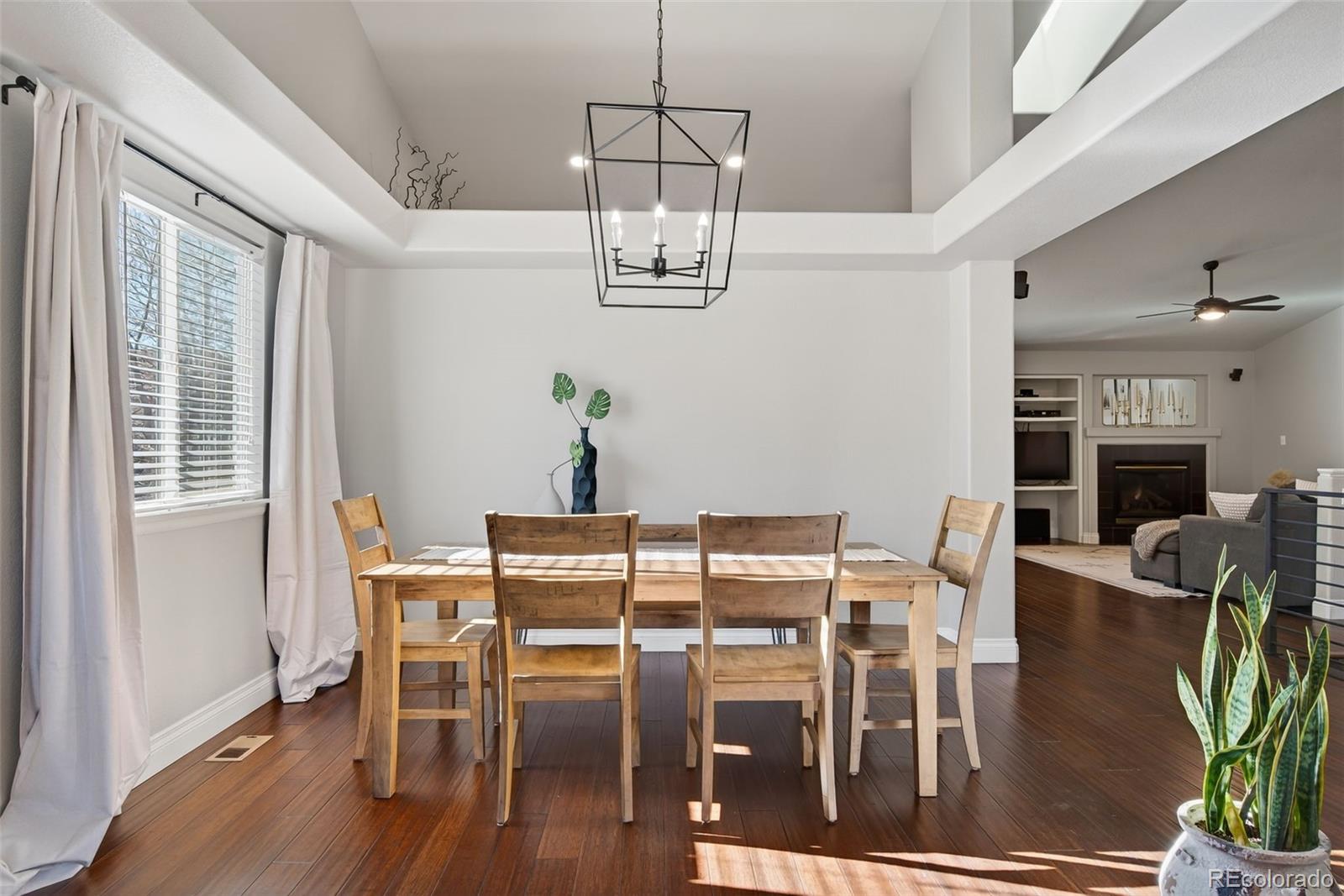 6737 Thistle Ridge Avenue Firestone, CO 80504 - Photo 13 of 39 a view of a dining room with furniture wooden floor and chandelier