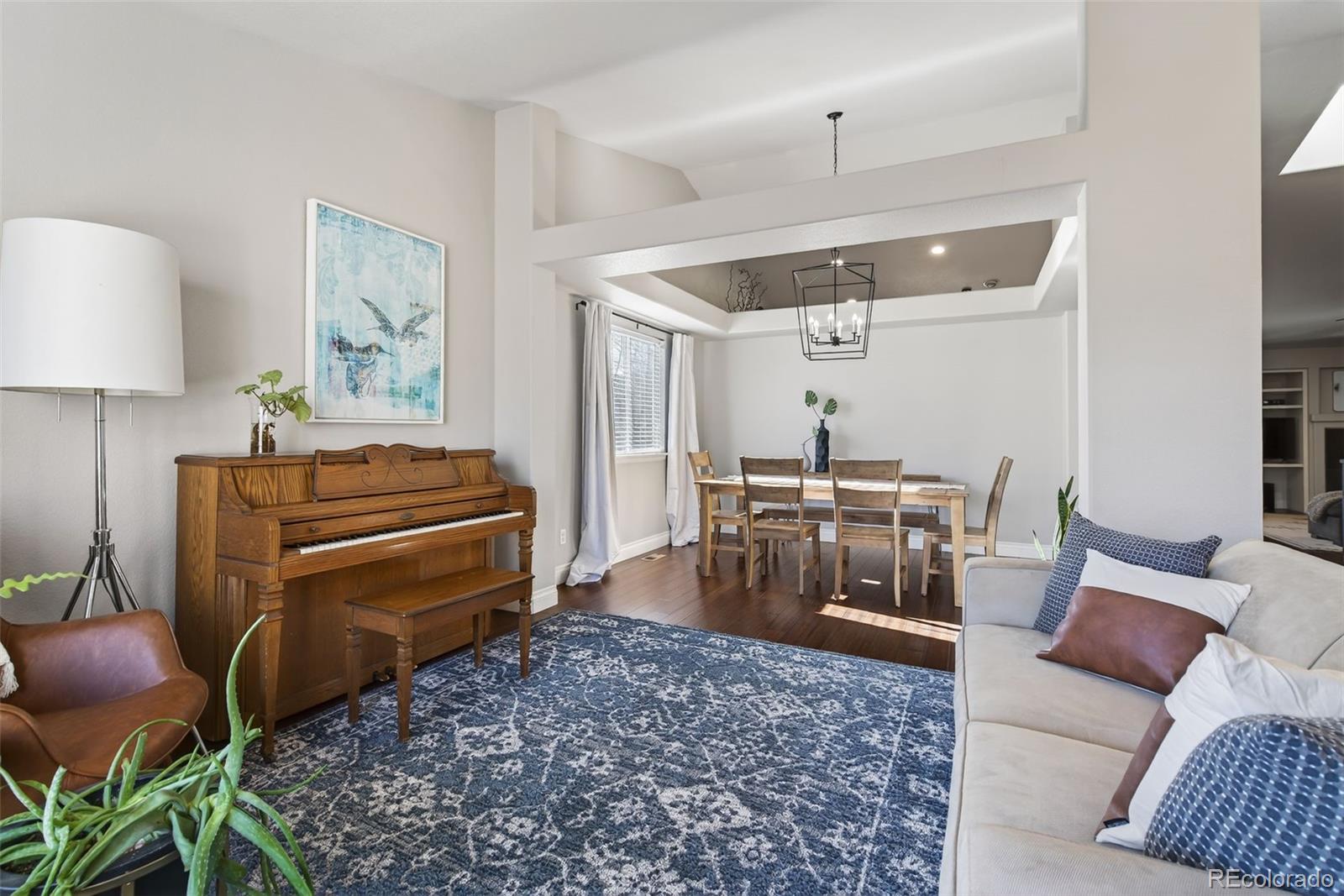 6737 Thistle Ridge Avenue Firestone, CO 80504 - Photo 14 of 39 a living room with furniture a ceiling fan and a rug