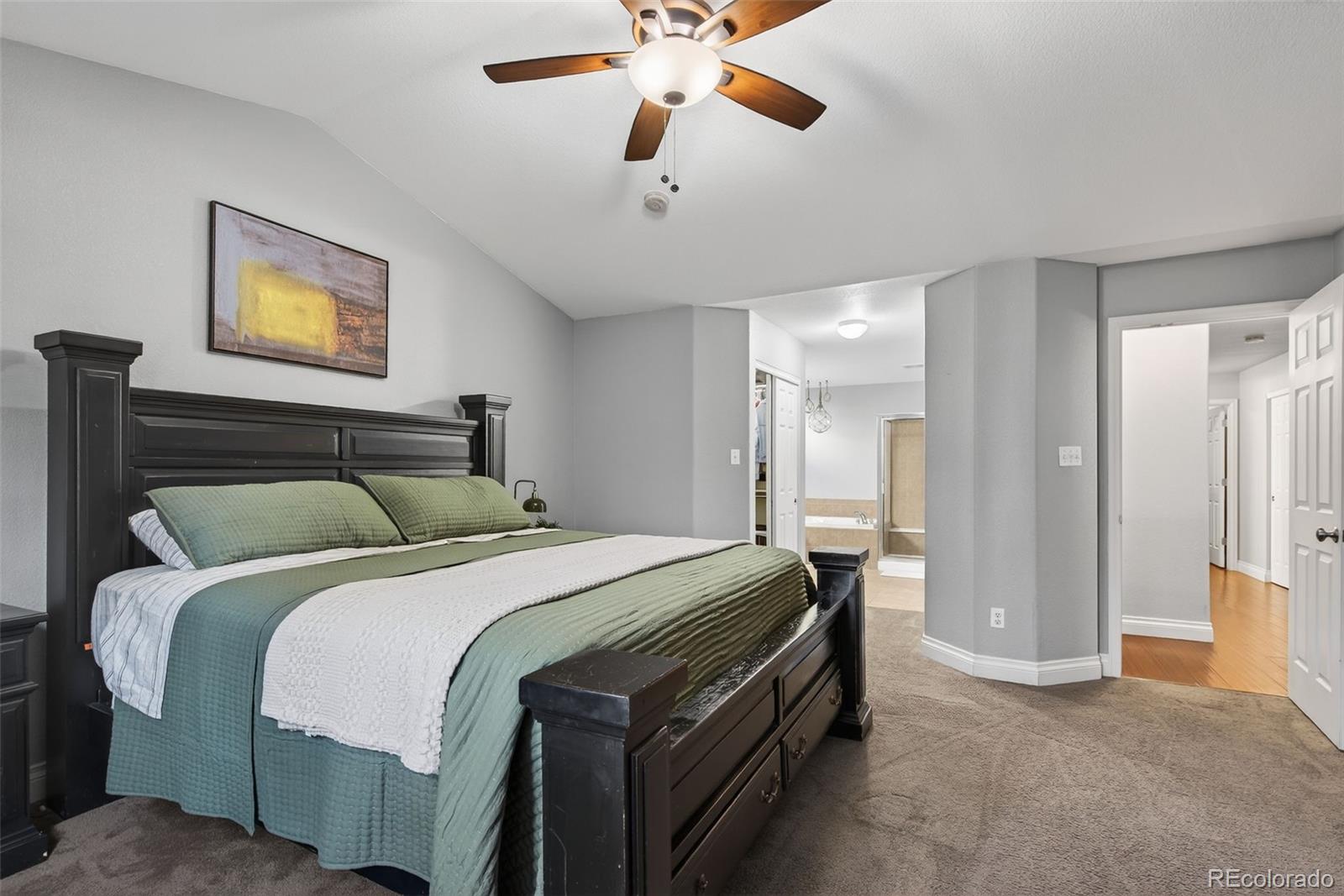 6737 Thistle Ridge Avenue Firestone, CO 80504 - Photo 16 of 39 a bedroom with a bed and a chandelier